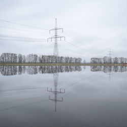 Scenic view of lake against sky during winter