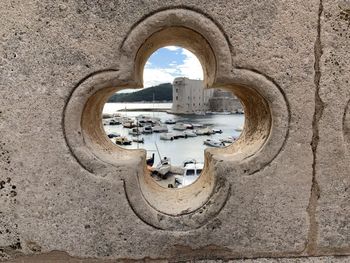 Buildings seen through hole in wall