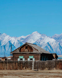 Scenic view of snowcapped mountains against clear blue sky