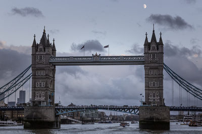 View of bridge over river against cloudy sky