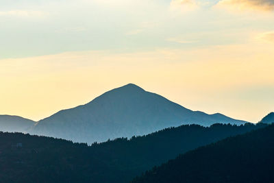 Scenic view of silhouette mountains against sky during sunset