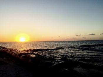 Scenic view of sea against clear sky during sunset