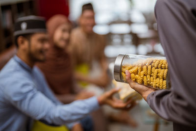 Midsection of person holding food in jar