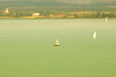 Sailboat on lake against sky