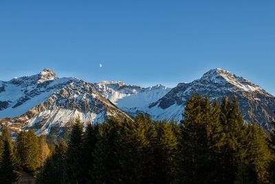 Scenic view of snowcapped mountains against clear sky