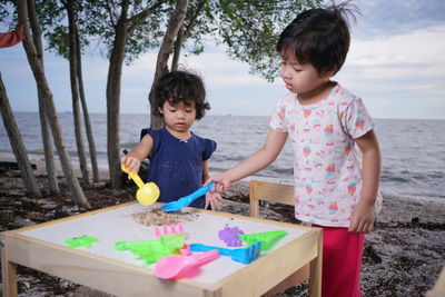 Boy playing with woman in traditional clothing