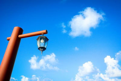 Low angle view of lamp against blue sky