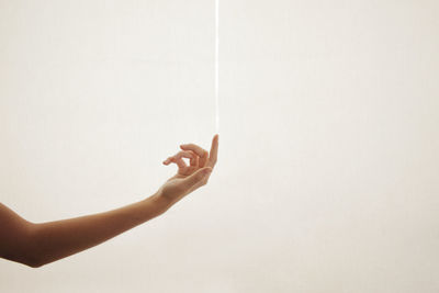 Person holding hand against white background