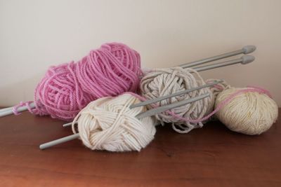 Close-up of knitting needle in wool on table