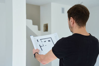 Side view of man using digital tablet in office