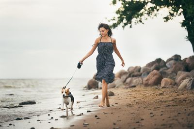 Full length of man with dog on beach
