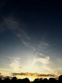 Low angle view of silhouette trees against sky