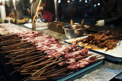 Close-up of meat at market stall during night
