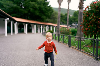 Full length of boy standing on bridge