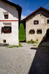 Houses by street against sky in city