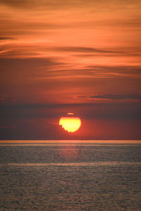 Scenic view of sea against orange sky