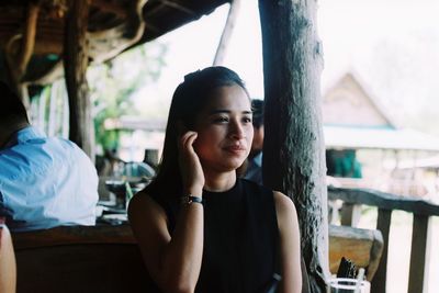 Portrait of young woman sitting outdoors