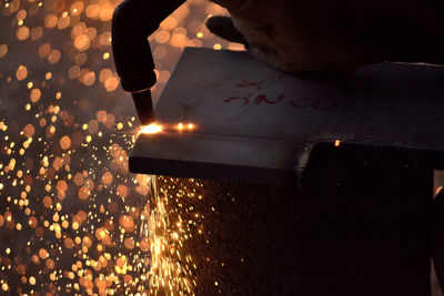 Close-up of hand with illuminated lights at night