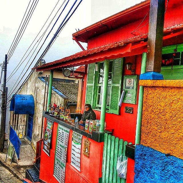 architecture, built structure, building exterior, red, hanging, day, connection, city, outdoors, cable, house, residential structure, residential building, communication, text, no people, multi colored, power line, non-western script, building