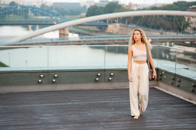 Portrait of young woman standing in city