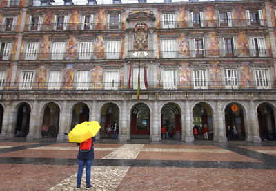 Rear view of woman with umbrella