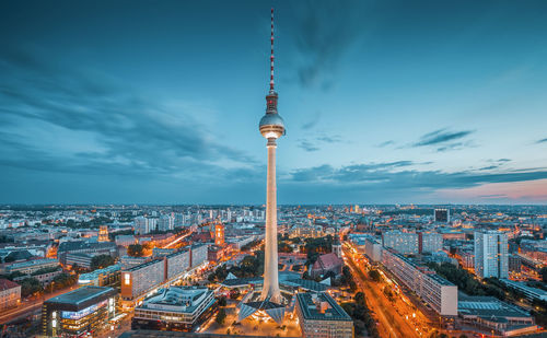 High angle view of illuminated city buildings against sky