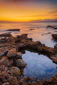 Scenic view of sea against sky during sunset