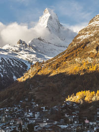 Aerial view of snowcapped mountains against sky