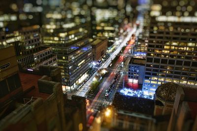 Tilt-shift image of illuminated cityscape at night