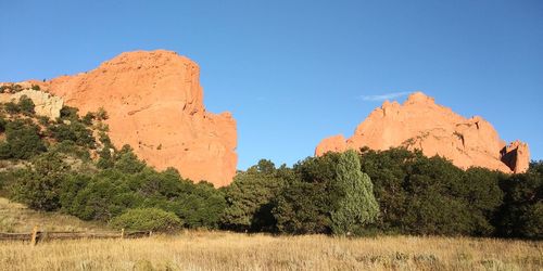 Panoramic view of rocks and trees against clear sky