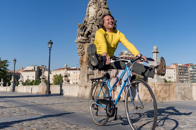 Happy man riding bicycle in the city