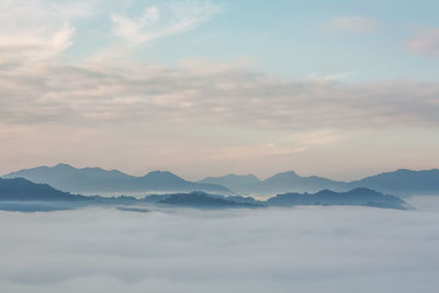 Scenic view of mountains against cloudy sky