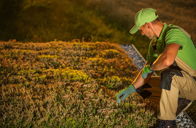 Rear view of man working at farm