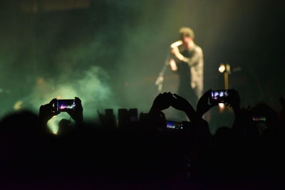 People photographing at music concert