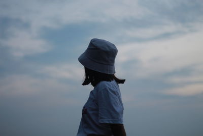 Rear view of woman standing against sky