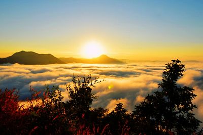 Scenic view of silhouette mountains against sky at sunset