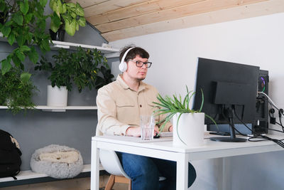 Portrait of young woman using laptop on table