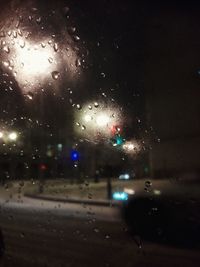 City street seen through wet glass window