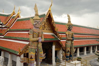 Low angle view of pagoda against cloudy sky