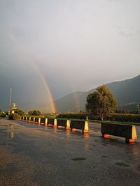 Scenic view of rainbow against sky during rainy season