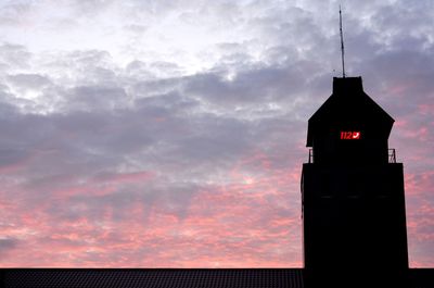 Low angle view of silhouette building against sky during sunset