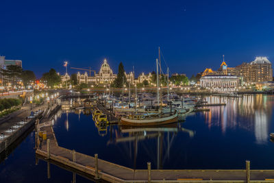 Sailboats in city at night