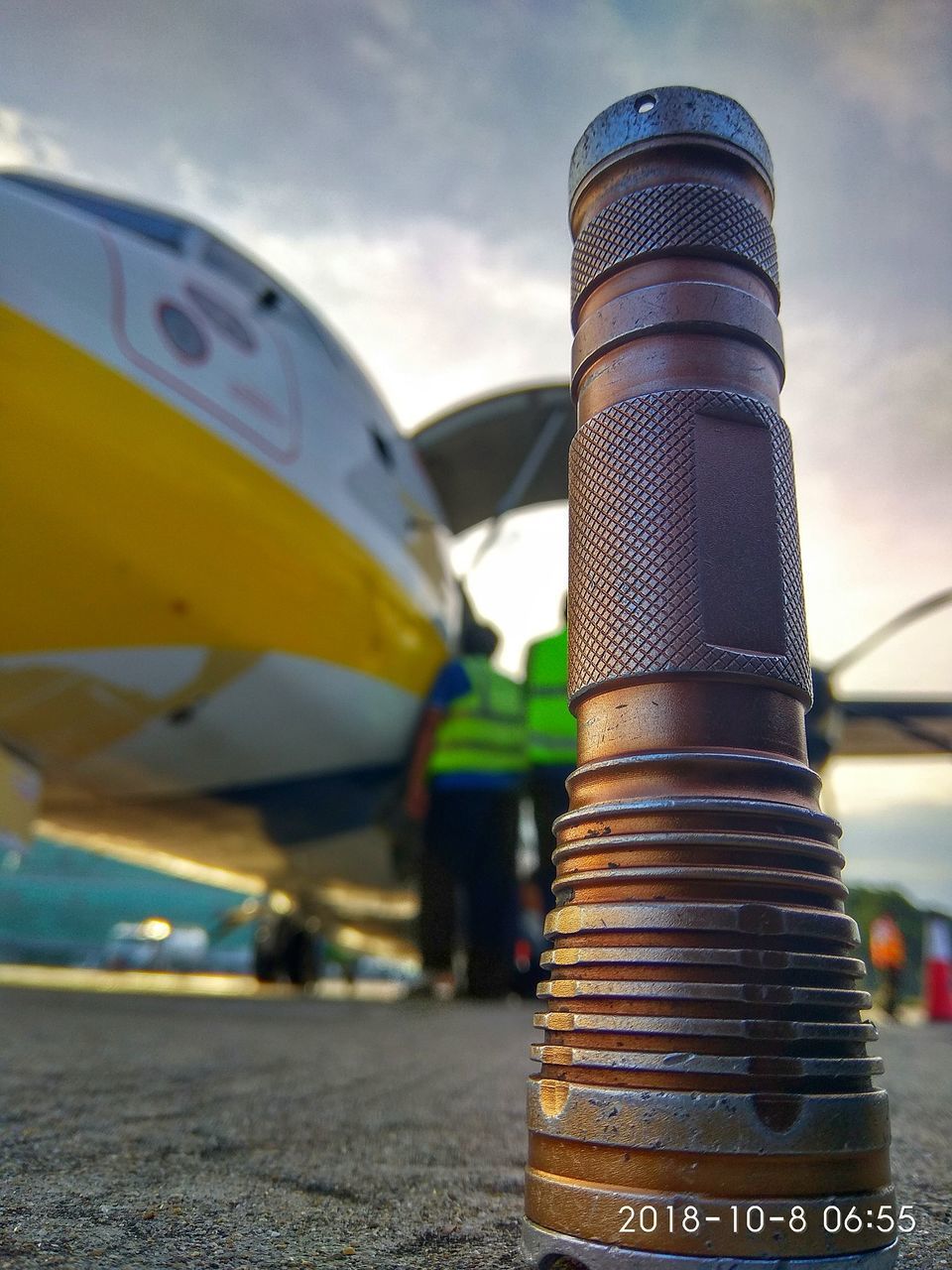 transportation, mode of transportation, focus on foreground, day, no people, close-up, sky, metal, nature, cloud - sky, outdoors, travel, land vehicle, sunlight, air vehicle, airplane, car, motor vehicle, yellow, moored