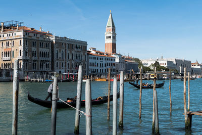 View of boats in canal against buildings