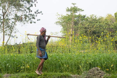 Full length of woman standing on field