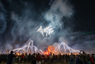 Crowd watching fireworks and celebrating new year eve