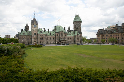 Buildings against cloudy sky