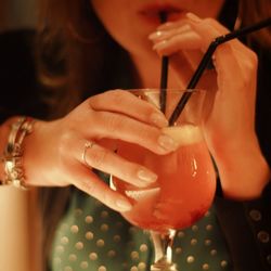 Midsection of a woman drinking glass