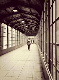 Woman walking in tunnel