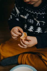 Child eating tangerine